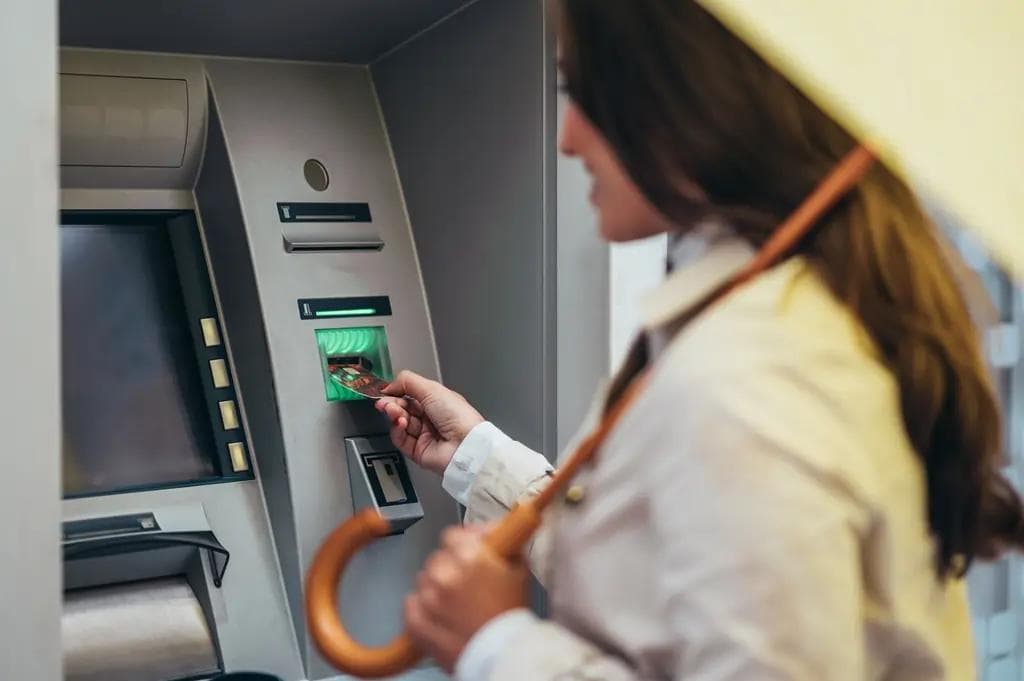 woman bank atm machine